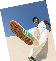 Creator kicking toward the camera in sneakers