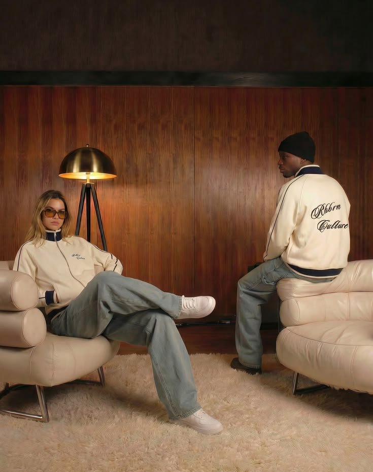 Two creators in matching branded jackets at a fashion shoot